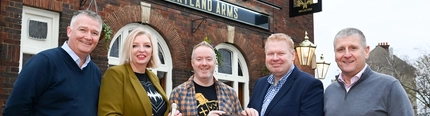 A group of people outside the Portland Arms.