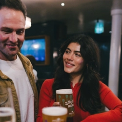 A lifestyle image of 3 friends stood at the bar enjoying various drinks within the interior of an Urban Core Venue.