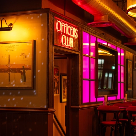 The interior seating area with neon light signage to lower level area at The City Of Quebec.