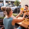 A group of people enjoying drinks within the exterior beer garden seating area during The Durell Arms launch party.