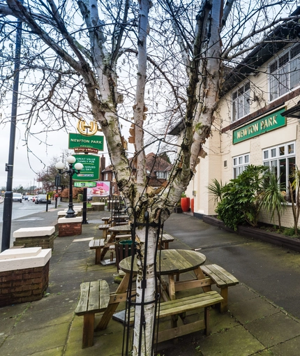 Exterior beer garden of a pub with a seating area.