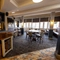 Interior dining area of a pub with a bar and a TV.