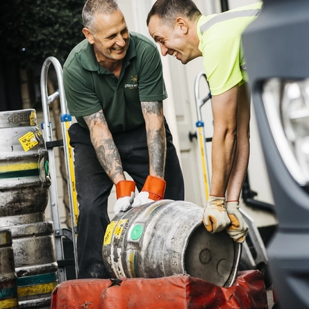 Two Beer Delivery/Draymen delivering kegs of beer.