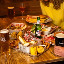 Main meals with drinks all served to a table of customers at a Flaming Grill venue.