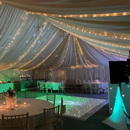A marquee, decorated for a wedding.