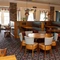 Interior dining area of a pub with TV screens.