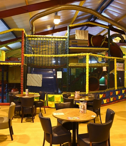 Interior play area of a pub with a seating area.