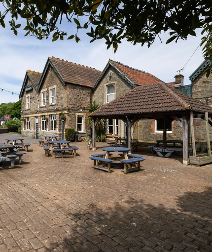 Exterior beer garden of a pub with a seating area.