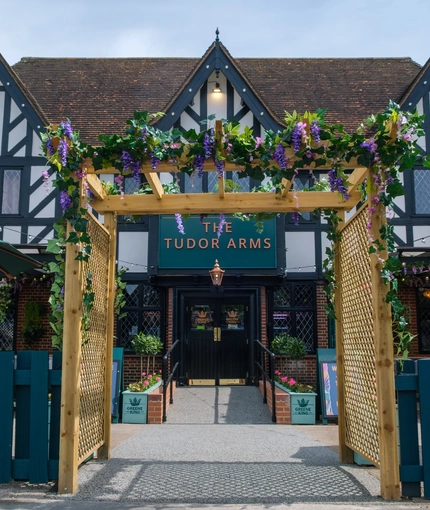 The exterior facade and seating area at the Tudor Arms.