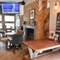Interior dining area of a pub with a TV and a fireplace.