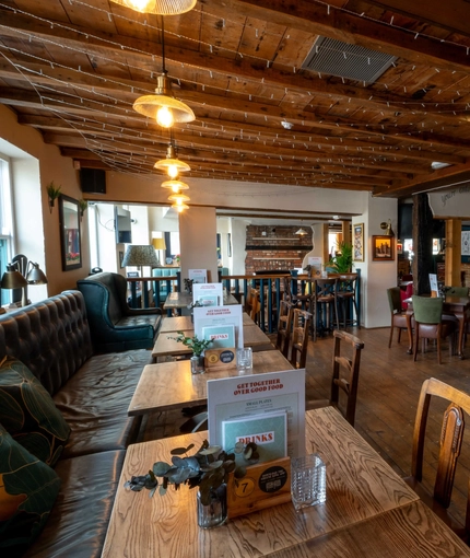 Internal seating area and restaurant area with the bar at the back at the George Abbot.