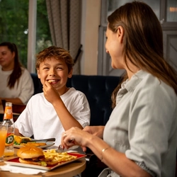A family sat at an indoor table enjoying a meal and drinks at a Hungry Horse venue.