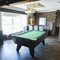 Interior dining area of a pub with a pool table.