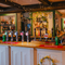 A close up view of the wood panelled bar inside The Green Man, with wooden beams and string lights on the ceiling. 