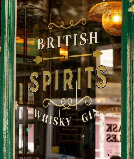 The exterior drinks advertising signage on a window panel at The Lucas Arms.