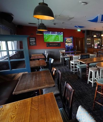 interior of the restaurant with seating area with TV
