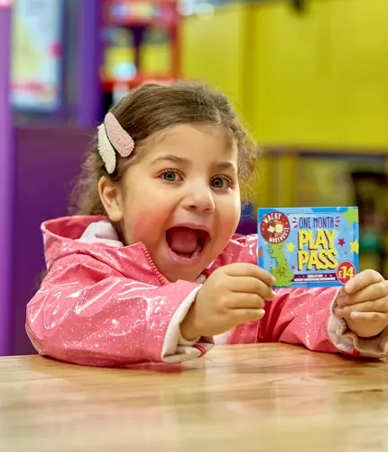 Child holding one month play pass