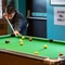 The interior games area with a man playing pool at the Hem Heath.