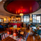 The interior restaurant seating area and small bar at the Two Chairmen in St James's, with upholstered seats, wooden flooring, and framed artwork on the walls.