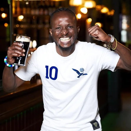 A man celebrating a goal in the pub