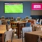 The interior restaurant and seating area with TV at The Woodlands.