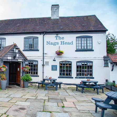 The exterior and beer garden of The Nags Head.