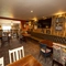 Interior dining area of a pub with a TV.