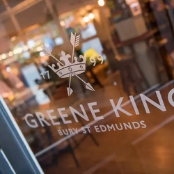 The Greene King logo on a door