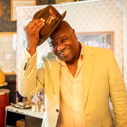 A historian 'Tony Fairweather' showing Greene King staff a staged Windrush Front Room during Black history month.