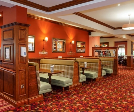 Interior dining area of a pub with a bar.