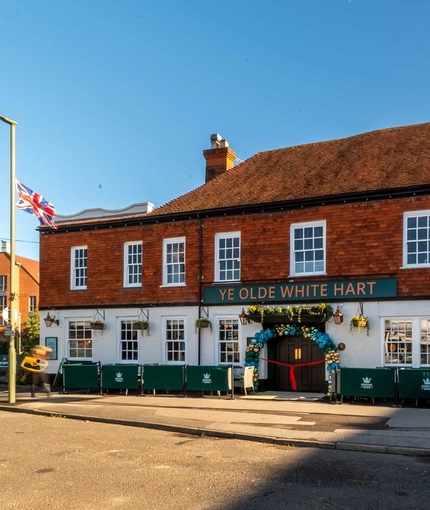The exterior facade and signage of The White Hart in Frimley.