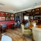 Interior dining area of a pub with a gambling machine.