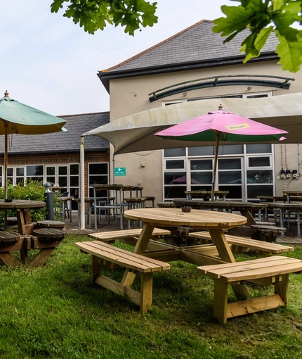 Exterior beer garden of a pub with a seating area.