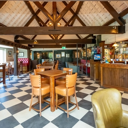 The interior bar and restaurant seating area with TV at The Moorhen.