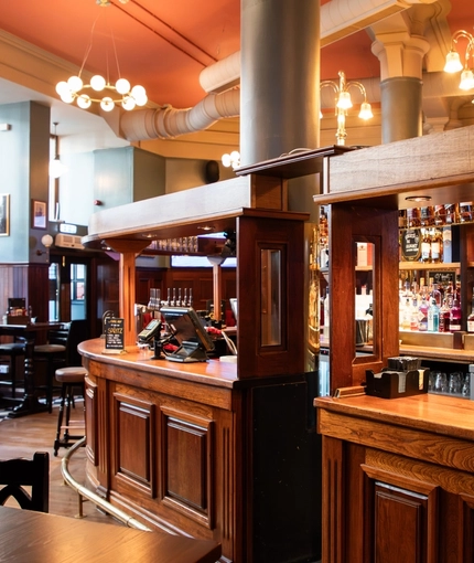 The wood panelled bar and interior restaurant seating area at the Rhoderick Dhu in Glasgow.