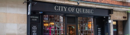 The exterior facade and beer garden seating area at The City Of Quebec.