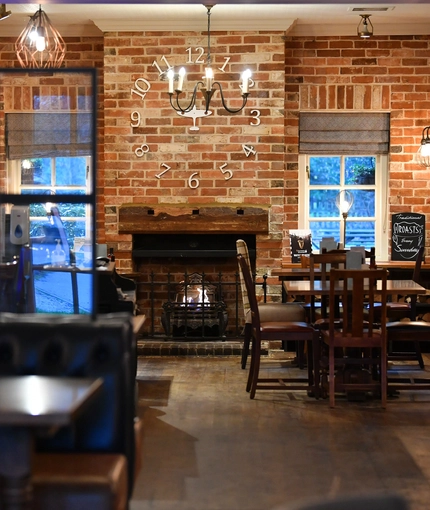 interior dining area of a pub with a fireplace