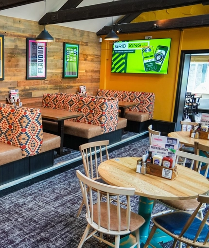 The interior restaurant and seating area with TV at the Pack Horse.