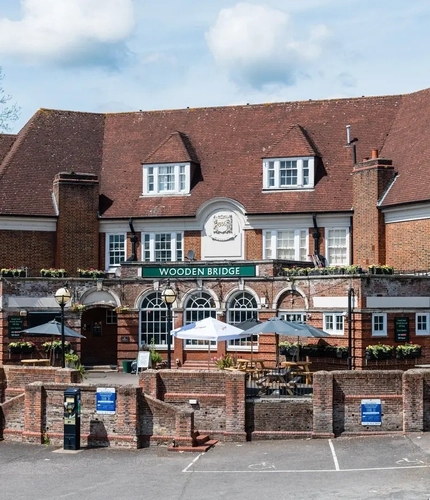Exterior facade of a pub with a seating area.