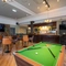 The interior pub games are with pool table, seating and bar area with TV at the Black Horse.