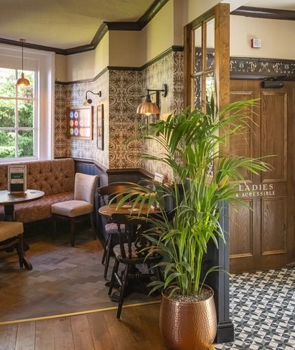 The interior restaurant seating area with feature fireplace at The Crown & Horseshoes.
