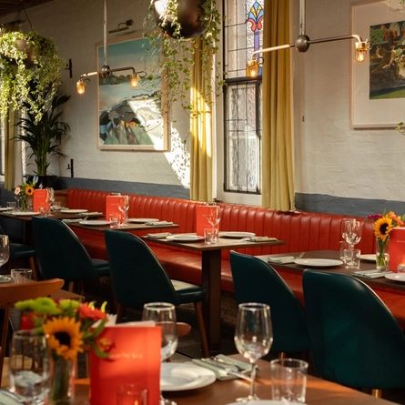 The interior restaurant and seating area with hanging plants at The Ubiquitous Chip.
