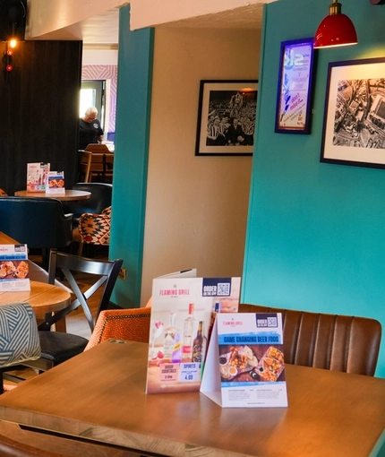 The interior restaurant and seating area with TV at the Pack Horse.