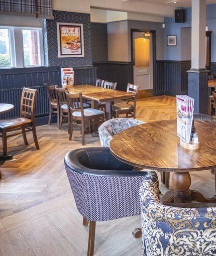 Interior dining area of a pub with a bar.