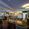 interior dining area of a pub with a bar and a TV