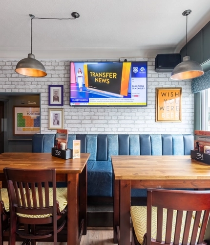 An interior shot of the restaurant, sport and seating area at the Waterside in Shoreham-By-Sea.