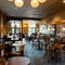 The interior restaurant seating area at The Richmond Arms, with upholstered chairs and booth seating; and framed artwork and a TV on the walls.