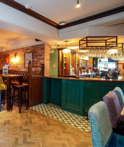 The interior bar and restaurant seating area at The Two Greens.