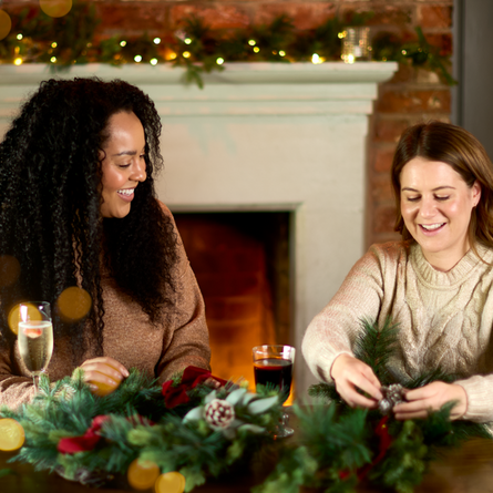 An image of 2 people enjoying drinks during a wreath making workshop at a Chef & Brewer venue.