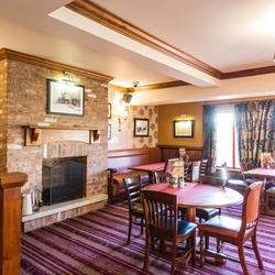 interior dining area of a pub with a fireplace